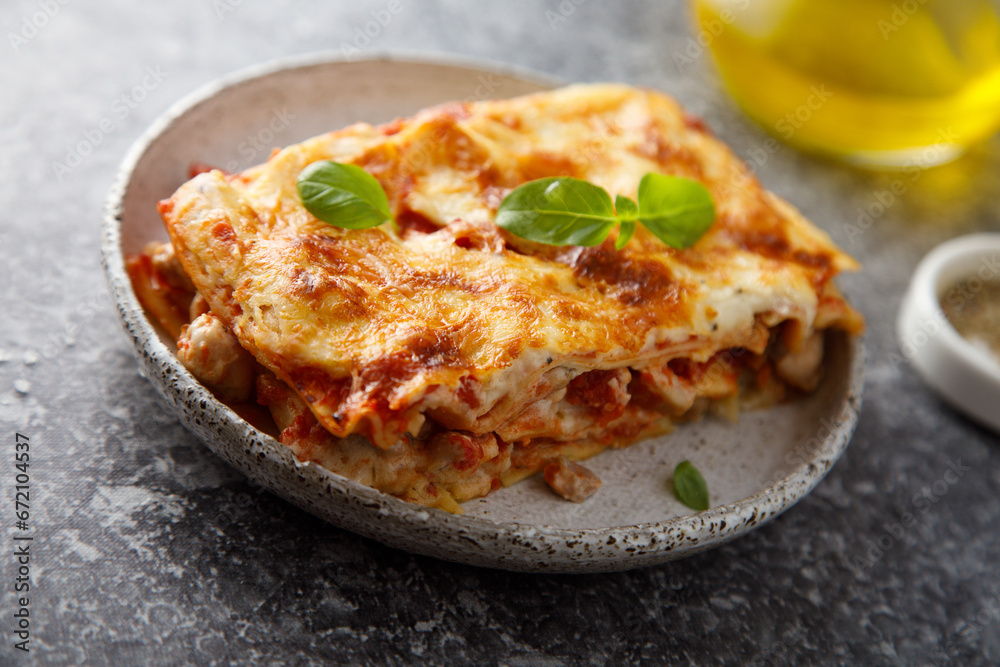 Traditional homemade lasagna with fresh basil