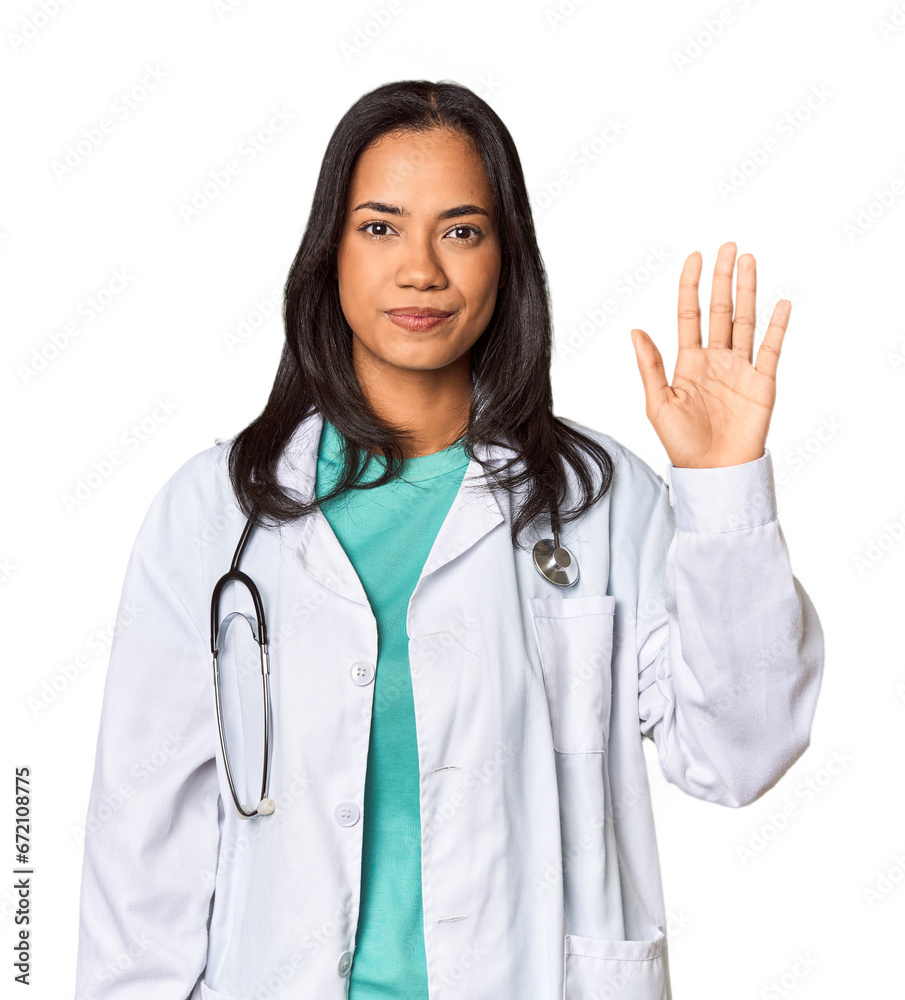 Young Filipina doctor with stethoscope in studio smiling cheerful showing number five with fingers. Young Filipina doctor with stethoscope in studio smiling cheerful showing number five with fingers.