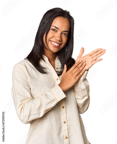 Young Filipina with long black hair in studio feeling energetic and comfortable, rubbing hands confident.