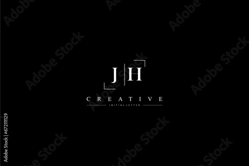 minimalist JH initial logo with simple vertical stroke line in black 110323