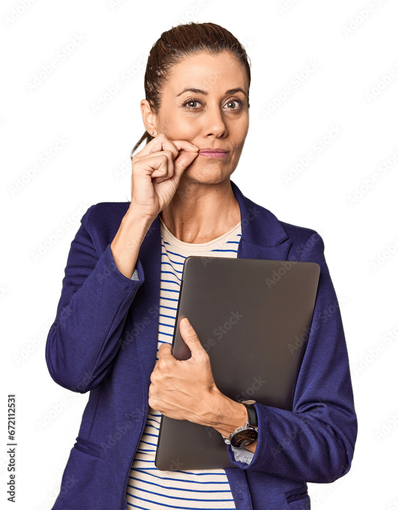 Middle-aged entrepreneur with laptop in studio with fingers on lips keeping a secret. Middle-aged entrepreneur with laptop in studio with fingers on lips keeping a secret.