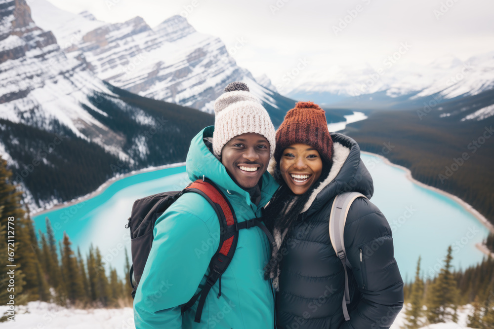 Portrait of a stylish black couple, with a backpack and jackets, with view of winter nature, mountains and the lake in the background. Peyto Lake, Alberta Portrait of a stylish black couple, with a backpack and jackets, with view of winter nature, mountains and the lake in the background. Peyto Lake, Alberta