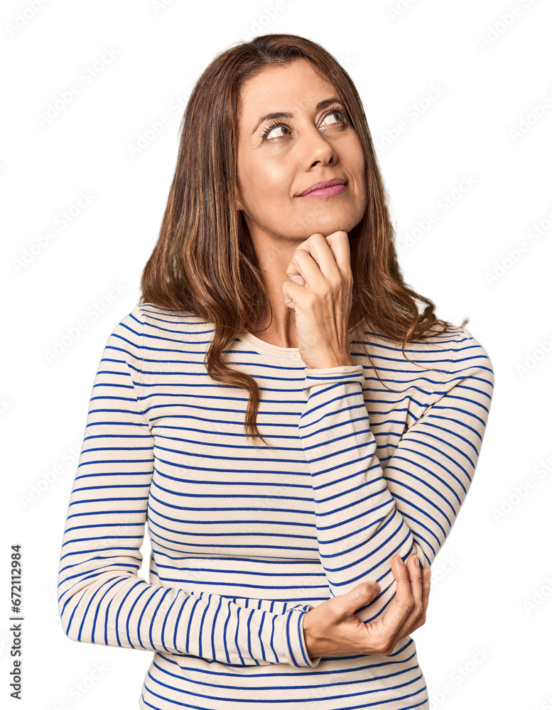 Middle-aged woman portrait in studio setting thinking and looking up, being reflective, contemplating, having a fantasy. Middle-aged woman portrait in studio setting thinking and looking up, being reflective, contemplating, having a fantasy.