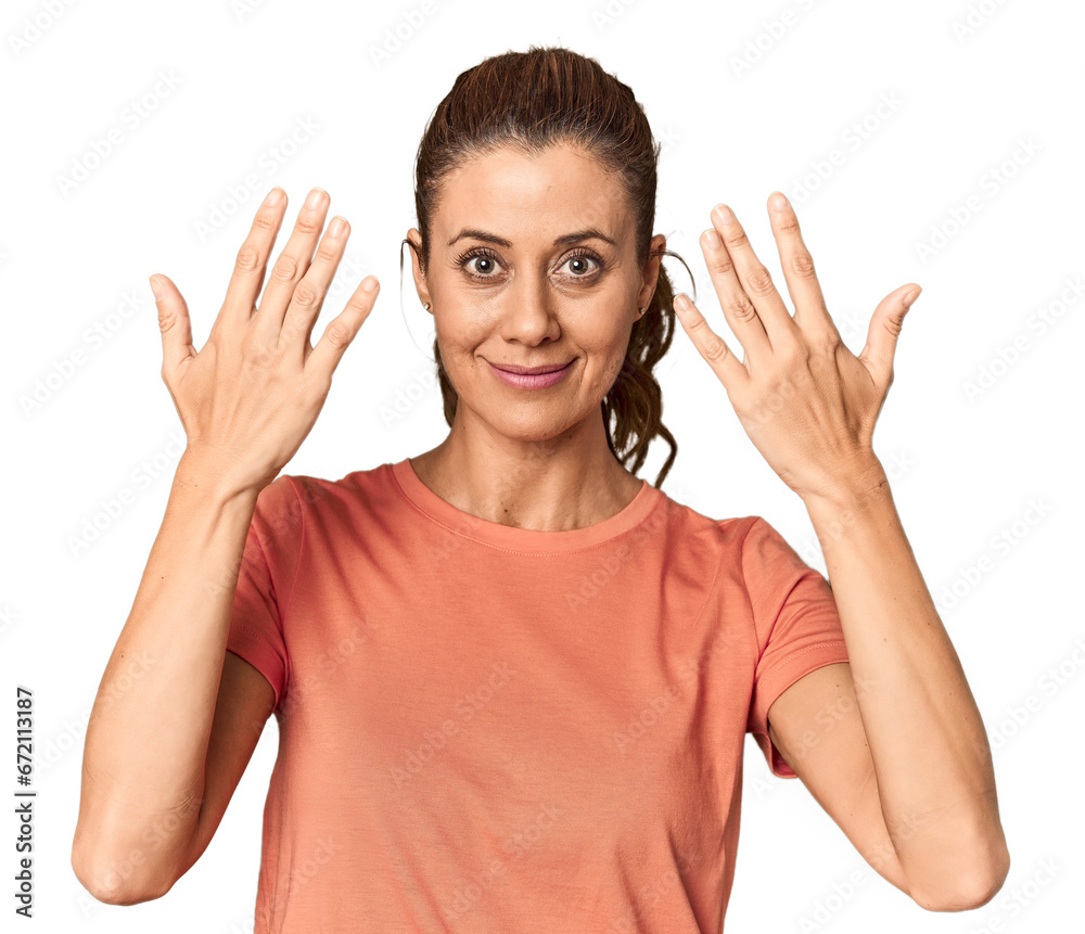 Joyful middle-aged woman posing contentedly in studio Joyful middle-aged woman posing contentedly in studio