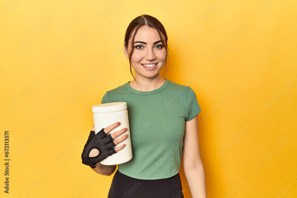 Fit woman holding a protein shake happy, smiling and cheerful. Fit woman holding a protein shake happy, smiling and cheerful.