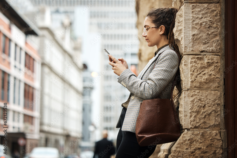 City wall, phone and business woman typing online research, reading email and scroll on website, app or social media. Urban sidewalk, cellphone and professional person relax on outdoor work break