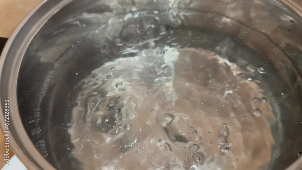 boiling water in a metal saucepan close-up boiling water in a metal saucepan close-up