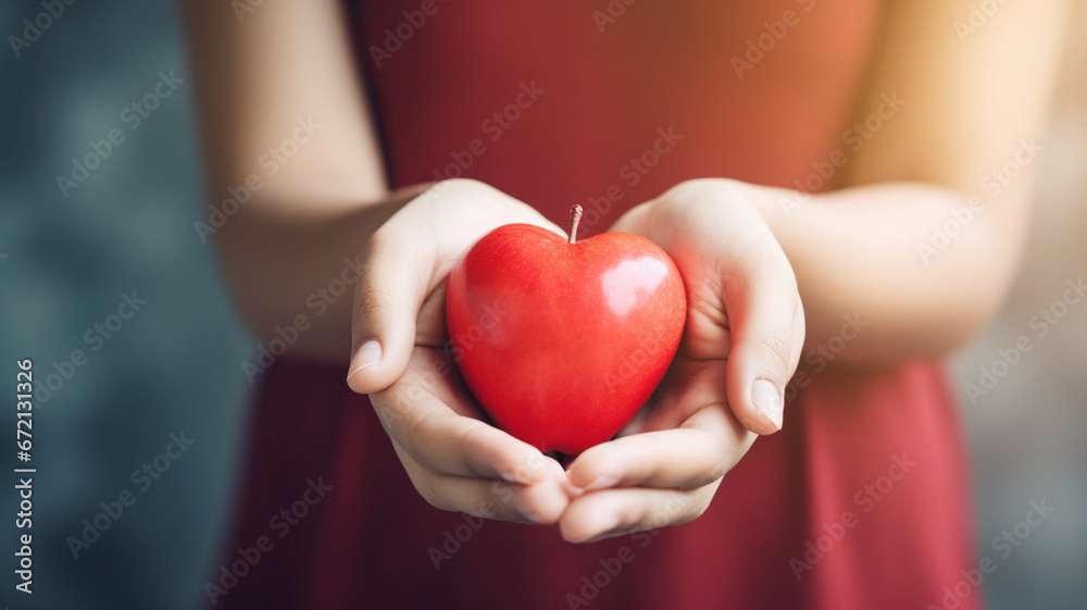 close up of woman 's hands holding red heart with blurred bokeh background. love and health care concept close up of woman 's hands holding red heart with blurred bokeh background. love and health care concept