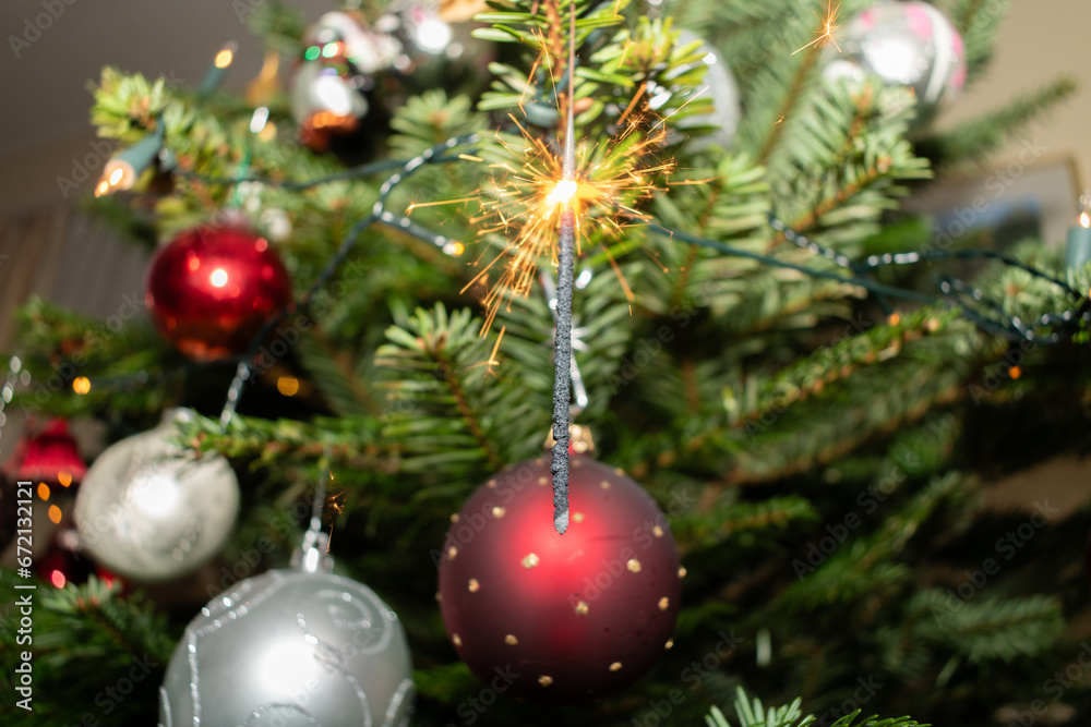 Bengal fire is sparkling on a christmas tree in Liechtenstein Bengal fire is sparkling on a christmas tree in Liechtenstein