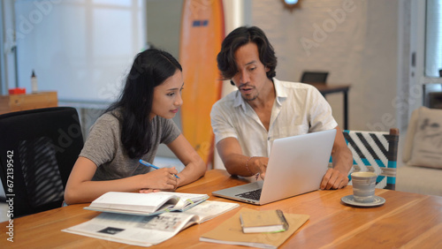 Asian people discuss work strategy plan. Man girl business meeting coworking cafe Asia. Chinese employee job talk together. Coworker persons teamwork start up project. Thai colleagues team conference.