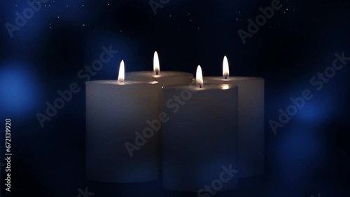 four bourning white candles in dark blue night with sparkling abstract starry sky animation, stationary decoration scene for december holiday season and merry christmas eve photo