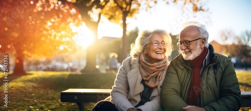 woman man senior couple happy retirement together elderly hug active bonding park outdoor sitting bench leisure fun smiling love old nature wife happiness mature