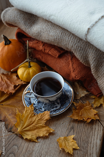 Cozy autumn morning breakfast in bed still life. a cup of hot coffee and tea are standing by the window. Autumn, Thanksgiving concept. White pumpkins and yellow leaves on a wool blanket.