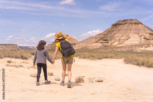Mother and daughter walking in a desert in national park