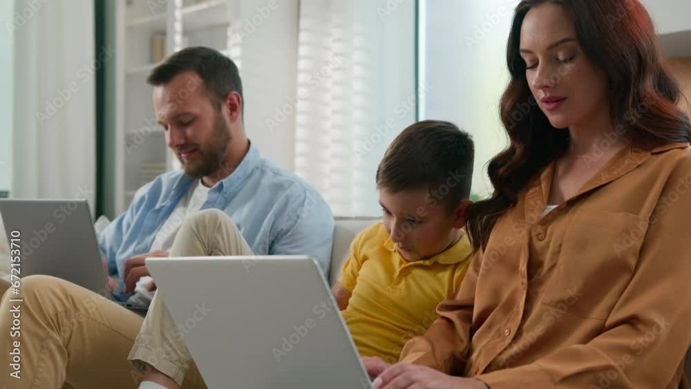 Addicted to modern technology dad mom son using different gadgets happy Caucasian family spend time together parents working remote on laptop at home on couch kid boy child playing video game on phone Addicted to modern technology dad mom son using different gadgets happy Caucasian family spend time together parents working remote on laptop at home on couch kid boy child playing video game on phone