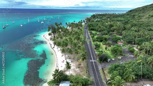 Cruising Along the Road Adjacent to Tahiamanu Beach, Moorea, French Polynesia - Drone Flying Forward photo