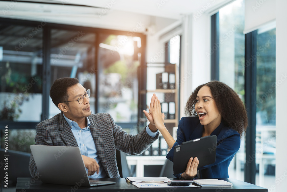 Happy creative business people are motivated, giving high five and celebration successful deal. Cooperation Meeting Partnership Career growth Team building Successful business.