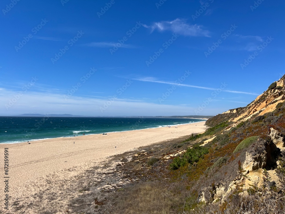Sandy ocean bay with wild beach, blue ocean horizon