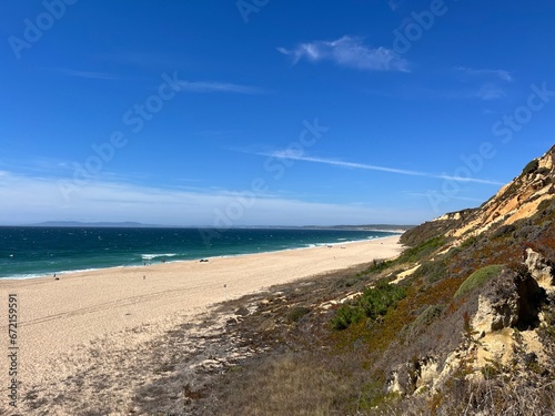 Sandy ocean bay with wild beach, blue ocean horizon