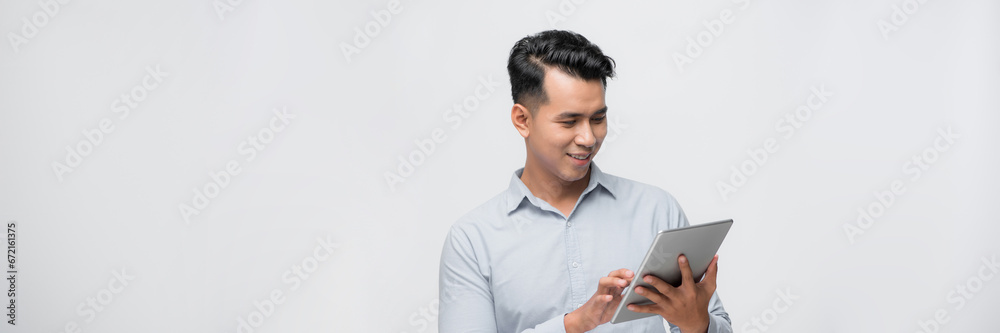 Banner of young Asian man having a smard pad PC isolated on white background. Banner of young Asian man having a smard pad PC isolated on white background.