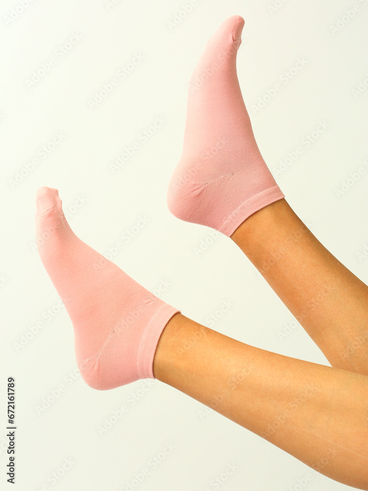pink socks with copy space on human foot close up photo on white background pink socks with copy space on human foot close up photo on white background