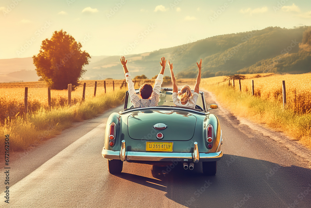 Couple on vacation on the roadtrip having fun driving a convertible car raising the arms to the sky. - obrazy, fototapety, plakaty 