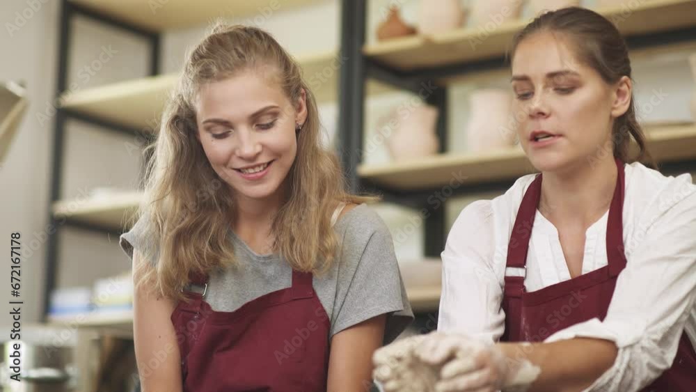 Pottery workshop, pretty woman make a workshop on pottery modeling for a young woman, production of handmade tableware. Pottery workshop, pretty woman make a workshop on pottery modeling for a young woman, production of handmade tableware.