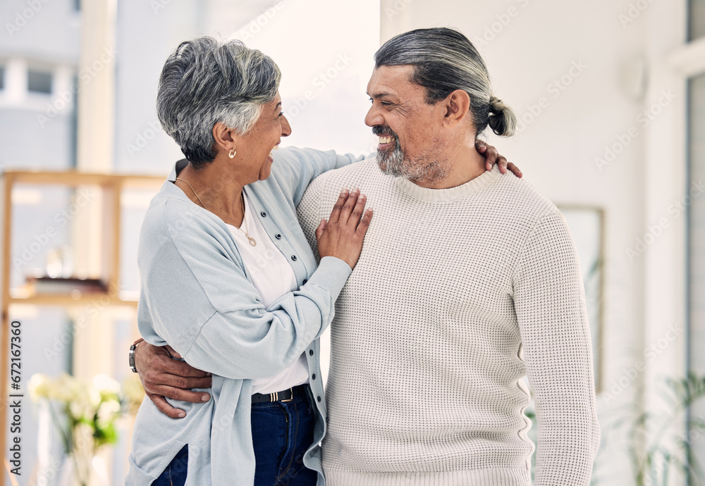 Fototapeta premium Hug, marriage and senior couple with love, quality time and care with happiness, home and relationship. Old woman, happy mature man or embrace in a lounge, loving together and romance with commitment