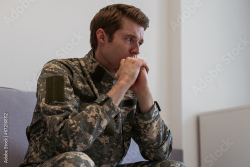 Thoughtful young handsome soldier in military uniform.