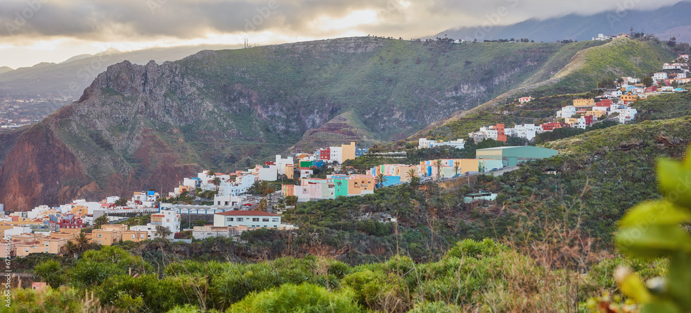 Fototapeta premium Colorful buildings in Santa Cruz, La Palma, Canary Islands with copy space. Beautiful cityscape with bright colors and mountains. A vibrant holiday, vacation and getaway destination on the hillside