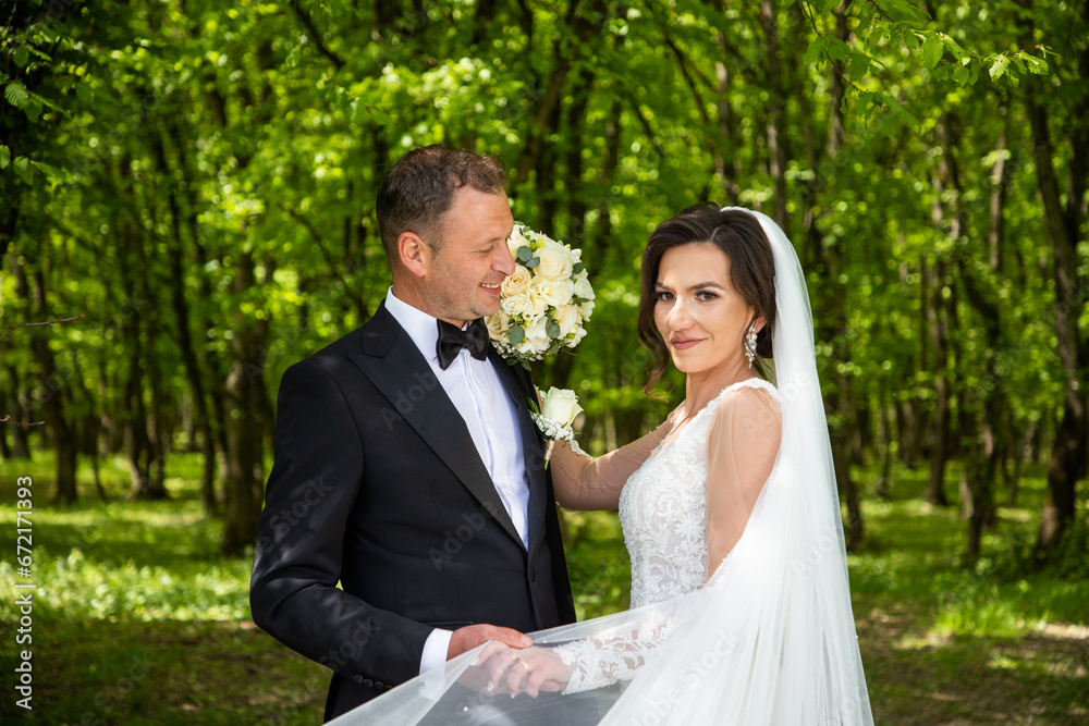 happy bride and groom posing on their wedding day happy bride and groom posing on their wedding day