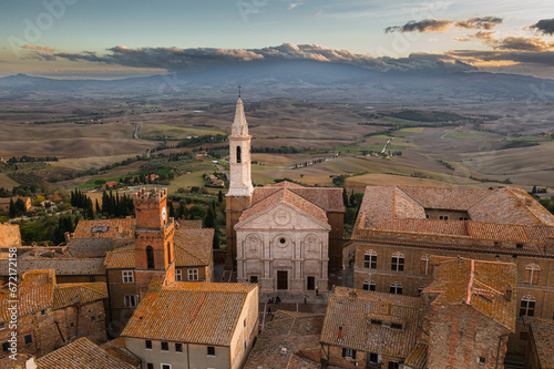 A captivating aerial view of a picturesque town in the heart of southern Tuscany, Italy. This drone-captured image showcases the charming beauty of Italian architecture, narrow streets, and a historic