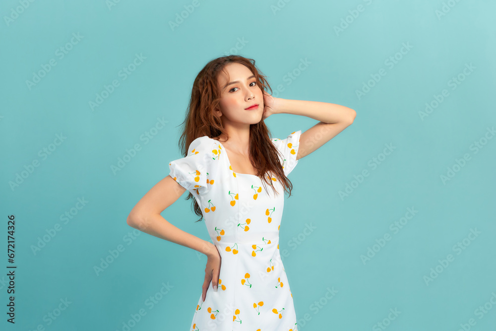 Obraz premium Portrait of young beautiful smiling female in trendy summer dress.