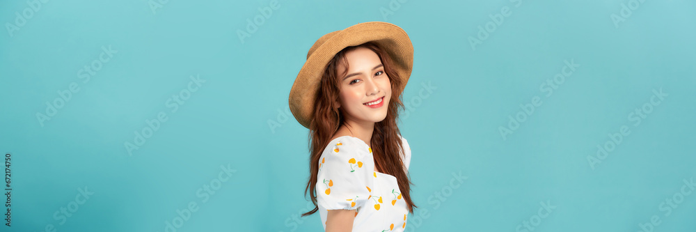 beautiful attractive stylish woman in straw hat posing on blue background - obrazy, fototapety, plakaty 