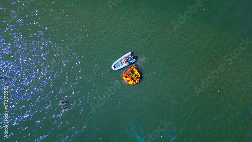A boat takes tourists out to sea. Italian famous seaside resort as seen from a drone. Summer vacation concept at sea. Rimini, Italy.