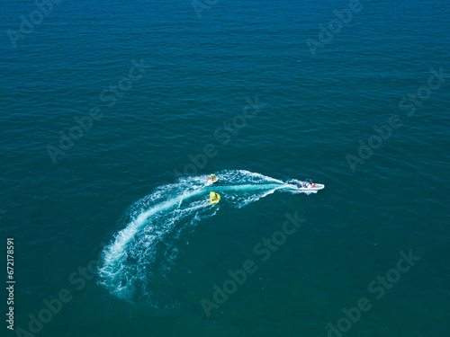 Sea attraction view from above. A boat takes tourists around the sea. Italy, Rimini © Andrew