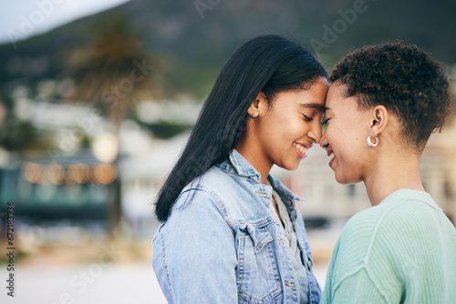 Women, lesbian and couple, hug and pride with gen z youth and romance, forehead touch outdoor. Female people together, gay relationship and lgbt with date, partner and trust with peace and support