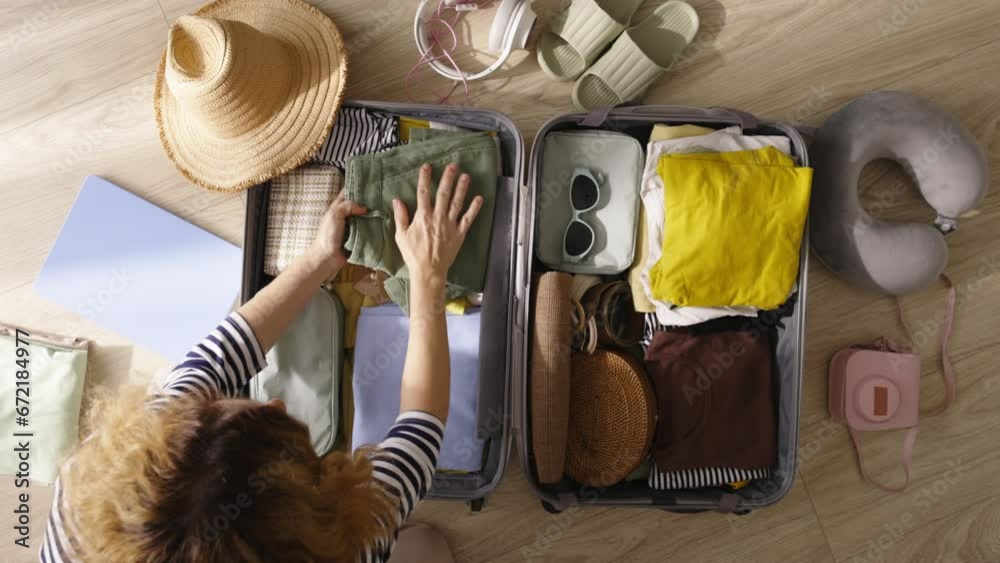 Packing suitcase top view. Excitement of well-deserved vacation, anticipation of relaxation and adventure. Joy of new experiences and create lifelong memories. Vacation dreams, preparation for travel