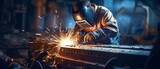 Craftsman using gas cutting machine in steel fabrication for construction industry sparks produced