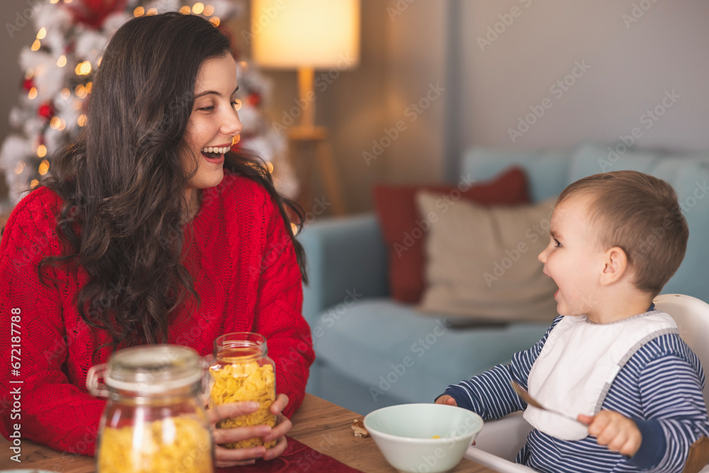 Cute toddler having breakfast on Christmas morning Cute toddler having breakfast on Christmas morning