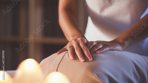 Women's hands make a massage back of young client on massage table, banner.
 photo