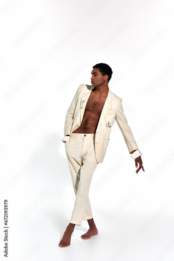 appealing sexy african american man in elegant suit in motion on white backdrop, fashion concept appealing sexy african american man in elegant suit in motion on white backdrop, fashion concept