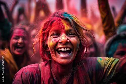 vibrant portrait of young woman face closeup at holi festival in India covered with colorful paint powder