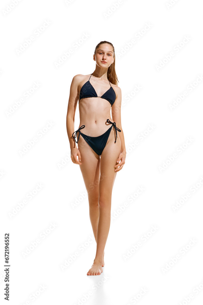 Portrait of beautiful fit woman with with perfect shape and ponytail hairstyle posing in black lingerie, swimsuit isolated studio background. Portrait of beautiful fit woman with with perfect shape and ponytail hairstyle posing in black lingerie, swimsuit isolated studio background.