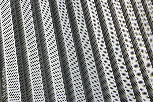 Perforated corrugated metal cladding sheet as background