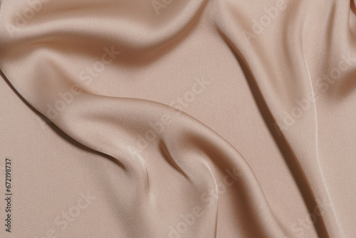 luxury crumpled and wrinkled beige polyester or synthetic fabric close-up. background for your design