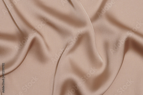 texture crumpled or wrinkled beige polyester or synthetic fabric close-up. Image for your design. material for sewing clothes