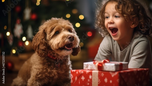 Photo of a Joyful Child and a Loyal Dog Celebrating Christmas with a Special Gift