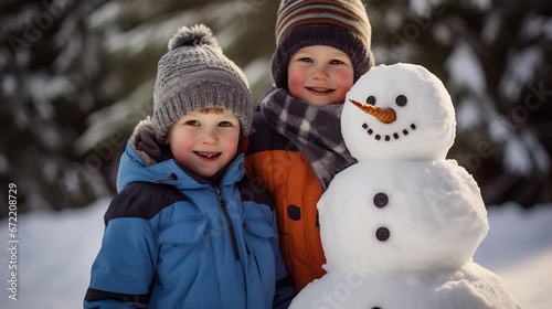 Portrait of two boys posing around cheerful funny snowman in winter park outdoors