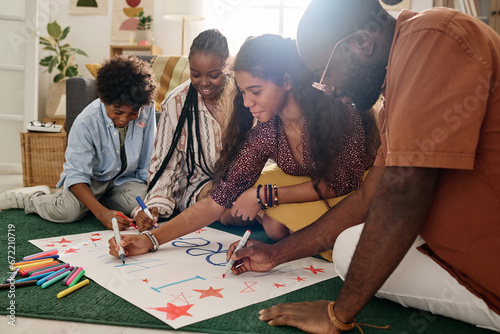 Black family spending time together drawing placard for Black History Month